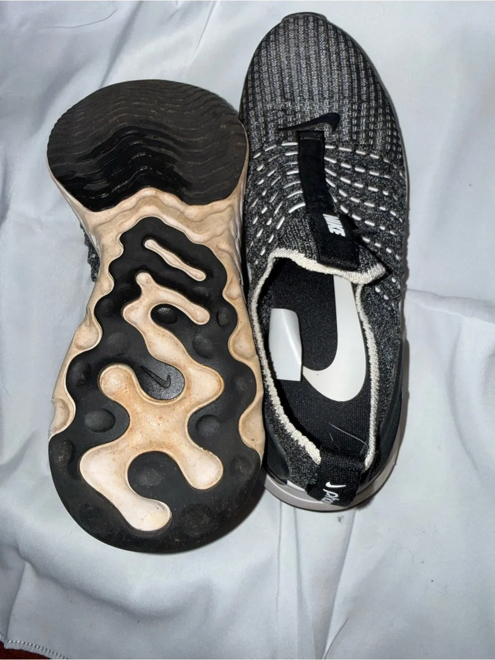 Nike women’s Black and Gray Knit Slip-On Sneakers